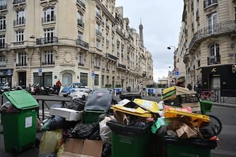 PARIS, FRANCE - MARCH 13: Garbage cans overflowing with trash on the streets as collectors go on strike in Paris, France on March 13, 2023. Garbage collectors have joined the massive strikes throughout France against pension reform plans. (Photo by Mustafa Yalcin/Anadolu Agency via Getty Images)