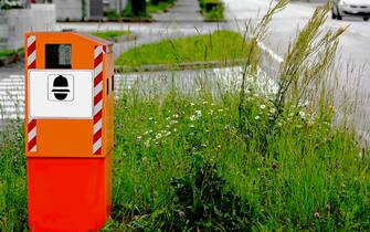 Orange system traffic enforcement camera on the side of road