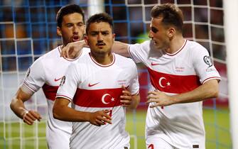 epa10695803 Cengiz Under (C) of Turkey teammates Umut Nayir (L) and Kerem Akturkoglu (R) after scoring the 1-2 goal during the UEFA EURO 2024 Group D qualifying match between Latvia and Turkey in Riga, Latvia, 16 June 2023.  EPA/TOMS KALNINS