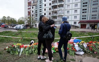 UMAN, CHERKASY OBLAST, UKRAINE - APRIL 30: People mourn in front of the flowers and toys brought by local residents in memory of the civilians who died as a result of a Russian airstrike at the strike site in the town of Uman, Cherkasy Oblast, Ukraine on April 30, 2023. (Photo by Oleksii Chumachenko/Anadolu Agency via Getty Images)