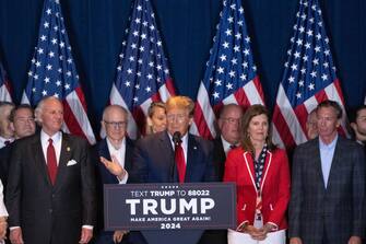 Former US President Donald Trump, center, speaks during an election night watch party at the South Carolina State Fairgrounds in Columbia, South Carolina, US, on Saturday, Feb. 24, 2024. Trump won the Republican presidential primary in South Carolina, according to AP, delivering a blow to rival Nikki Haley in her home state as the former president continues his sweep of the 2024 nominating contests. Photographer: Victor J. Blue/Bloomberg via Getty Images