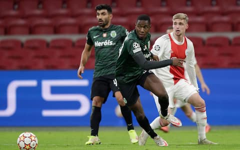 AMSTERDAM, NETHERLANDS - DECEMBER 7: Ricardo Esgaio of Sporting CP, Dario Essugo of Sporting CP, Kenneth Taylor of Ajax during the UEFA Champions League match between Ajax and Sporting Clube de Portugal at Johan Cruijff ArenA on December 7, 2021 in Amsterdam, Netherlands (Photo by Peter Lous/BSR Agency/Getty Images)