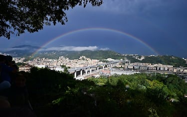 A rainbow is seen over the new San Giorgio bridge on the inauguration day on August 3 , 2020 in Genoa, the new high-tech structure will have four maintenance robots running along its length to spot weathering or erosion, as well as a special dehumidification system to limit corrosion. - Italy inaugurates a sleek new bridge in Genoa, though relatives of the 43 people killed when the old viaduct collapsed say the pomp and ceremony risk overshadowing the tragedy. (Photo by MIGUEL MEDINA / AFP) (Photo by MIGUEL MEDINA/AFP via Getty Images)