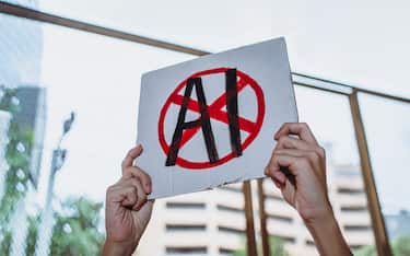 Protestor holding "No AI" placard