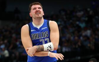 DALLAS, TEXAS - NOVEMBER 08: Luka Doncic #77 of the Dallas Mavericks holds his elbow after a fall in the second quarter against the Toronto Raptors at American Airlines Center on November 08, 2023 in Dallas, Texas. NOTE TO USER: User expressly acknowledges and agrees that, by downloading and or using this photograph, User is consenting to the terms and conditions of the Getty Images License Agreement.  (Photo by Richard Rodriguez/Getty Images)