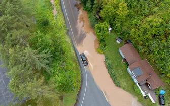 LONDONDERRY, VERMONT - JULY 10: In an aerial view, a pick-up truck drives along a flooded road after heavy rain on July 10, 2023 in Londonderry, Vermont. Torrential rain and flooding has affected millions of people from Vermont south to North Carolina. (Photo by Scott Eisen/Getty Images)