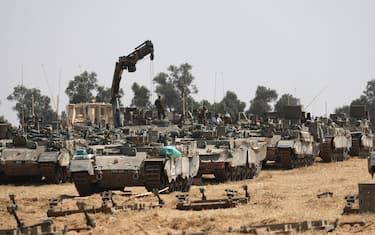 epa11312277 Israeli soldiers with military vehicles gather at a position on the southern Israeli border with the Gaza Strip, near the Palestinian city of Rafah, 01 May 2024. More than 34,300 Palestinians and over 1,455 Israelis have been killed, according to the Palestinian Health Ministry and the Israel Defense Forces (IDF), since Hamas militants launched an attack against Israel from the Gaza Strip on 07 October 2023, and the Israeli operations in Gaza and the West Bank which followed it.  EPA/ATEF SAFADI