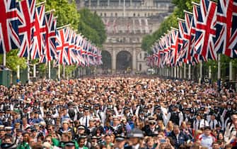 LONDON, ENGLAND - JUNE 02: Crowds on The Mall watch, as Queen Elizabeth II makes an appearance on the balcony of Buckingham Palaceduring Trooping The Colour on June 2, 2022 in London, England.Trooping The Colour, also known as The Queen's Birthday Parade, is a military ceremony performed by regiments of the British Army that has taken place since the mid-17th century. It marks the official birthday of the British Sovereign. This year, from June 2 to June 5, 2022, there is the added celebration of the Platinum Jubilee of Elizabeth II  in the UK and Commonwealth to mark the 70th anniversary of her accession to the throne on 6 February 1952. (Photo by Aaron Chown - WPA Pool/Getty Images)