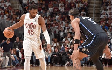 CLEVELAND, OH - APRIL 22: Donovan Mitchell #45 of the Cleveland Cavaliers handles the ball against Paolo Banchero #5 of the Orlando Magic during the game during Round 1 Game 2 of the 2024 NBA Playoffs on April 22, 2024 at Rocket Mortgage FieldHouse in Cleveland, Ohio. NOTE TO USER: User expressly acknowledges and agrees that, by downloading and/or using this Photograph, user is consenting to the terms and conditions of the Getty Images License Agreement. Mandatory Copyright Notice: Copyright 2024 NBAE (Photo by David Liam Kyle/NBAE via Getty Images)