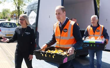 Britain's Prince William, Prince of Wales helps to unload trays of food from van of Surplus to Supper, a surplus food redistribution charity, as he arrives in Feltham, on April 18, 2024, to visit Hanworth Centre Hub, a youth centre which provides a range of services to create a safer and better-connected community. (Photo by Ian Vogler / POOL / AFP) (Photo by IAN VOGLER/POOL/AFP via Getty Images)