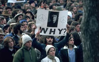 December 1980:  Fans of John Lennon holding a vigil after he was shot dead by a fan on December 8th at his home in New York.  (Photo by Hulton Archive/Getty Images)