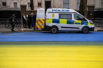 LONDON, ENGLAND - FEBRUARY 23: In this handout provided by Led By Donkeys, Activists from political campaign group Led By Donkeys, pour paint onto the road to create a giant Ukrainian flag outside the Russian Embassy on February 23, 2023 in London, England. The group created the flag using washable paint poured onto the road and then driven through by passing vehicles to show solidarity with Ukraine on the eve of the one year mark since the Russian invasion of Ukraine began. (Photo by Handout/Led By Donkeys via Getty Images)