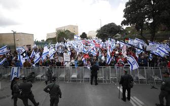 epa10545091 Protesters gather outside the Knesset ahead of mass protests in Jerusalem, Israel, 27 March 2023. Mass protests have been held in Israel for 12 weeks against the government's plans to reform the justice system and limit the power of the Israeli Supreme Court.  EPA/ATEF SAFADI