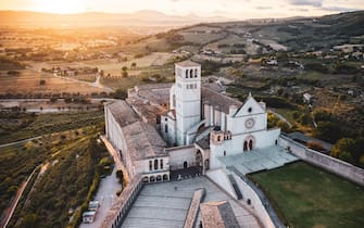 ITALY, UMBRIA, ASSISI: Aerial view of the San Francesco d’Assisi Cathedral at sunset