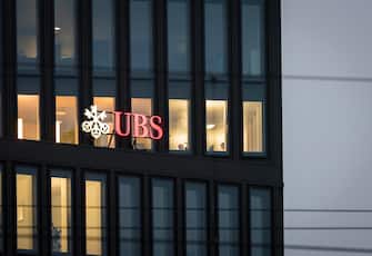 Early in the morning, the lights are switched on in some offices of a UBS bank office building at Zurich, Switzerland.