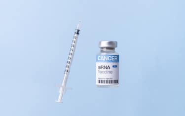 Front view of syringe and mRNA vaccine multidose vial for cancer immunotherapy (We look forward to seeing this coming into being)