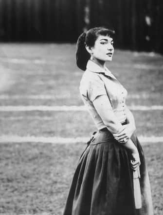 1956:  Portrait of Greek-American opera singer Maria Callas (1923 - 1977), standing outdoors in a field and holding a hand fan, Rome, Italy.  (Photo by Tony Vaccaro/Hulton Archive/Getty Images)