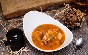 Spicy New Orleans Gumbo soup with shrimp, vegetables and hunting sausages