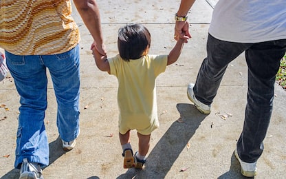 Miami Florida,Chinese New Year Festival,Asian girl child holds parents hand hands,