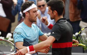 epa06787420 Marco Cecchinato of Italy (L) reacts with Novak Djokovic of Serbia after winning their menâs quarter final match during the French Open tennis tournament at Roland Garros in Paris, France, 05 June 2018.  EPA/GUILLAUME HORCAJUELO