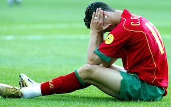 epa000210387 Portugals national team soccer player  Cristiano Ronaldo in desperation after the Greece score the second goal agaisnt Portugal at the start match of Euro 2004 Championship in Dragao stadiun on Saturday, 12 June 2004.  EPA/ESTELA SILVA NO MOBILEPHONE APPLICATIONS