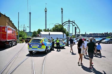 A photo taken on June 25, 2023 shows police at the Grona Lund amusement park, after an accident occurred in the 'Jetline' roller coaster leaving one person dead. A carriage in the 'Jetline' roller coaster has derailed and fallen from a height of several meters. One person died and several people have been injured, according to Swedish media reports on June 25. The amusement park is being evacuated and the police have set up cordons. (Photo by Claudio BRESCIANI / various sources / AFP) / Sweden OUT (Photo by CLAUDIO BRESCIANI/TT NEWS AGENCY/AFP via Getty Images)