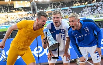 epa10700520 Finnish players Lukas Hradecky (L), Daniel Hakans (C) and Richard Jensen (R) celebrate after the UEFA European Qualifiers match between Finland and San Marino in Helsinki, Finland, 19 June 2023. Finland won the match 6-0.  EPA/COMPIC