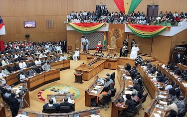 Ghana's President John Dramani Mahama (C, L) delivers his State of the Nation address at the Parliament on February 25, 2014 in Accra, Ghana. The president of resource-rich Ghana, seen as a beacon of democracy in a turbulent region, unveiled economic reforms on February 25, as a free-falling currency sparks frustration over living costs.   AFP PHOTO / CHRIS STEIN        (Photo credit should read Chris Stein/AFP via Getty Images)