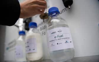 06 November 2019, Baden-Wuerttemberg, Eggenstein-Leopoldshafen: A bottle of e-Fuels stands on the North Campus of the Karlsruhe Institute of Technology (KIT) in a research facility with which CO2-neutral fuel can be produced from air and green electricity using "Power-to-X" technologies (P2X). The plant was officially put into operation. Photo: Marijan Murat/dpa (Photo by Marijan Murat/picture alliance via Getty Images)
