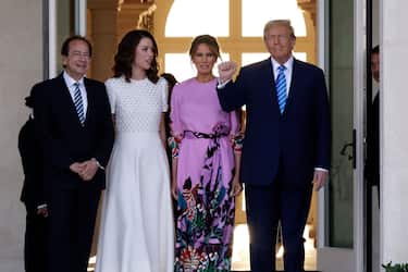 PALM BEACH, FLORIDA - APRIL 06: Republican presidential candidate and former US President Donald Trump (R) and former first lady Melania Trump (2nd-R) arrive at the home of John (L) and Jenny Paulson (2nd-L) on April 6, 2024 in Palm Beach, Florida. Trump's campaign is expecting to raise more than 40 million dollars, when major donors gather for a fundraiser billed as the "Inaugural Leadership Dinner". (Photo by Alon Skuy/Getty Images)