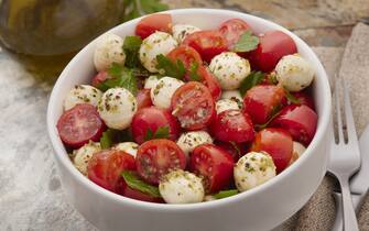 Caprese Salad with Mozzarella, Cherry Tomatoes, Italian Parsley and a Vinaigrette Dressing