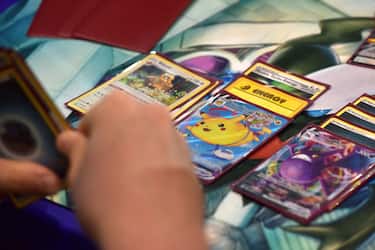 LONDON, ENGLAND - AUGUST 18: A competitor holds a deck containing a Flying Pikachu Vmax card while playing Pokemon cards during the 2022 PokÃ©mon World Championships at ExCel on August 18, 2022 in London, England. For the first time in history, the championship event is being held outside of North America, London Excel will host the competition on August 18â  21. Some of the best PokÃ©mon players from around the will compete in PokÃ©mon TCG, the PokÃ©mon Sword and PokÃ©mon Shield video games, PokÃ©mon GO, PokÃ©mon UNITE, and PokkÃ©n Tournament DX. Half a million dollars in prizes, the title of PokÃ©mon World Champion, and return invitations for the following year's Worlds are up for grabs. (Photo by John Keeble/Getty Images)