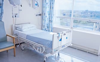 Empty hospital bed on hospital ward