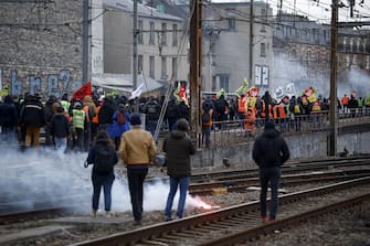 epa10546849 Railway workers take part in a demonstration against government pension reform at Lyon train station in Paris, France, 28 March 2023. France faces an ongoing national strike against the government's pensions reform after Prime Minister Elisabeth Borne on 16 March announced the use of article 49 paragraph 3 (49.3) of the Constitution of France to have the text on the controversial pension reform law to be definitively adopted without a vote.  EPA/YOAN VALAT