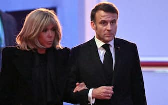 French President Emmanuel Macron and his wife Brigitte Macron arrive to attend commemorations on the 80th anniversary of the liberation of the German Nazi concentration and extermination camp Auschwitz-Birkenau by the Red Army, in Oswiecim, Poland on January 27, 2025. (Photo by Sergei GAPON / AFP)