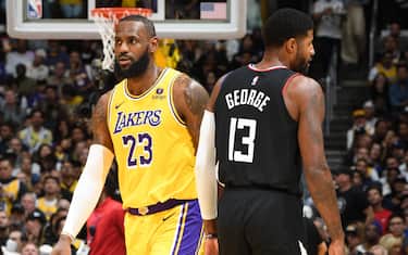 LOS ANGELES, CA - NOVEMBER 1: LeBron James #23 of the Los Angeles Lakers and Paul George #13 of the LA Clippers look on during the game on November 1, 2023 at Crypto.Com Arena in Los Angeles, California. NOTE TO USER: User expressly acknowledges and agrees that, by downloading and/or using this Photograph, user is consenting to the terms and conditions of the Getty Images License Agreement. Mandatory Copyright Notice: Copyright 2023 NBAE (Photo by Andrew D. Bernstein/NBAE via Getty Images)