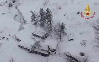 epa05729985 A handout picture provided by the Italian Fire Department shows an aeroal view of hotel Rigopiano after it was hit by an avalanche in Farindola (Pescara), Abruzzo region, early 19 January 2017. According to an Italian mountain rescue team, several people have been killed in an avalanche that has hit a hotel near the Gran Sasso mountain in Abruzzo region. Authorities believe that the avalanche was apparently triggered by a series of earthquakes in central Italy on 18 January.  EPA/ITALIAN FIRE DEPARTMENT HANDOUT BEST QUALITY AVAILABLE HANDOUT EDITORIAL USE ONLY/NO SALES