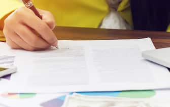 business woman hand signing a contract, close up. contract agreement or business deal concept