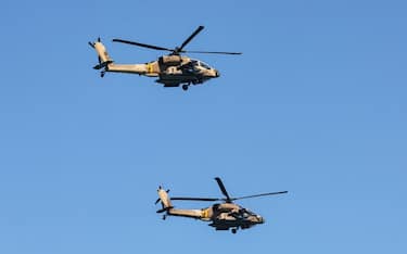 Israeli Air Force AH-64 Apache attack helicopters fly over during an air show in Tel Aviv on April 26, 2023, as Israel marks Independence Day (Yom HaAtzmaut), 75 years since the establishment of the Jewish state. (Photo by JACK GUEZ / AFP) (Photo by JACK GUEZ/AFP via Getty Images)