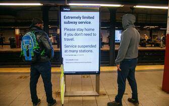 epa10890881 Straphangers stand near a digital sign warning travelers about the weather affecting subway service in New York, New York, USA, 29 September 2023. New York Governor Kathy Hochul declared a State of Emergency as flash flooding affects the New York City area due to heavy rain.  EPA/SARAH YENESEL