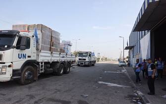 UN aid is loaded on lorries to be distributed to Palestinian families and displaced families, many of whom fled the northern areas of the Gaza Strip following Israel's call to move south for their safety, in Deir al-Balah on October 28, 2023, amid the ongoing battles between Israel and the Palestinian group Hamas. Thousands of civilians, both Palestinians and Israelis, have died since October 7, 2023, after Palestinian Hamas militants based in the Gaza Strip entered southern Israel in an unprecedented attack triggering a war declared by Israel on Hamas with retaliatory bombings on Gaza. (Photo by MOHAMMED ABED / AFP) (Photo by MOHAMMED ABED/AFP via Getty Images)