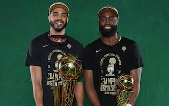 BOSTON, MA - JUNE 17: Jayson Tatum #0 and Jaylen Brown #7 of the Boston Celtics pose for a portrait with the Larry O'Brian Trophy and with the The Bill Russell Finals MVP Trophy after winning Game 5 of the 2024 NBA Finals on June 17, 2024 at the TD Garden in Boston, Massachusetts. NOTE TO USER: User expressly acknowledges and agrees that, by downloading and or using this photograph, User is consenting to the terms and conditions of the Getty Images License Agreement. Mandatory Copyright Notice: Copyright 2024 NBAE  (Photo by Jesse D. Garrabrant/NBAE via Getty Images)