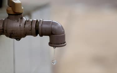 salvador, bahia, brazil - july 24, 2023: water drop coming out of a faucet in the city of Salvador.