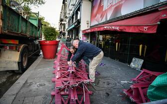 Workers remove the wings of the Moulin Rouge cabaret in Paris on April 25, 2024, after it collapsed last evening. The wings of the windmill on top of the famous Moulin Rouge cabaret fell off during the night on Wednesday the Paris fire department said. No injuries were reported, they said, adding that there was no longer any risk of further collapse. The reasons for the fall are currently unknown. It caused damage to the front of the cabaret, bringing down with it the first three letters of the illuminated sign. Images on social media showed the blade unit lying on the street below, with some of the blades slightly bent from the apparent fall. Photo by Firas Abdullah/ABACAPRESS.COM