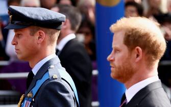 The Prince of Wales and Duke of Sussex follow the coffin of Queen Elizabeth II, draped in the Royal Standard with the Imperial State Crown placed on top, as it is carried on a horse-drawn gun carriage of the King's Troop Royal Horse Artillery, during the ceremonial procession from Buckingham Palace to Westminster Hall, London, where it will lie in state ahead of her funeral on Monday. Picture date: Wednesday September 14, 2022.