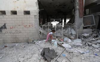 epa10932243 A girl walks on rubble following an Israeli airstrike at Al-Ansar Mosque at Jenin refugee camp on 22 October 2023. At least two people were killed in an early morning Israeli forces airstrike on Al Ansar mosque in Jenin, according to Palestinian Health Ministry. The Israeli Defense Forces said the airstrike was targeting the Hamas and Islamic Jihad terrorist compound in the Al-Ansar Mosque in Jenin.  EPA/ALAA BADARNEH