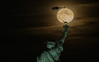 NEW YORK, USA - AUGUST 30: Supermoon rises over the Statue of Liberty in New York, USA on August 30, 2023. (Photo by Fatih Aktas/Anadolu Agency via Getty Images)