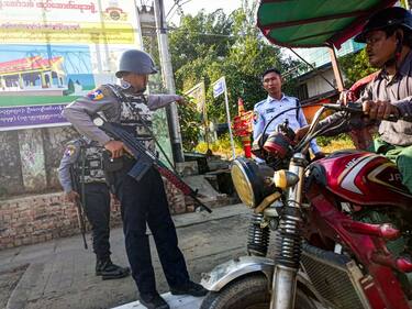 Armed policemen inspect a tricycle at a roadside checkpoint during the visit of the Myanmar junta leader Min Aung Hlaing to Thanlyin township, on the outskirts of Yangon on December 24, 2022.
 (Photo by STR/NurPhoto via Getty Images)