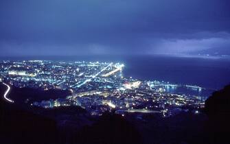 REGGIO, ITALY - CIRCA JULY 2003:  (FILE-PHOTO)  (ITALY-OUT)  A general view of the strait of Messina, taken from the town of Reggio Calabria, with the lights of Messina, Italy, on the upper right of the frame, are shown circa July 2003 in Reggio, Calabria, Italy. The EU parliament decided March 13, 2004 to include a bridge over the Strait of Messina in its list of planned pan-European network projects. The project was approved by architect Dr. William Brown, the architect for the Bosforo bridge. The project calls for building the longest suspension bridge in the world, approximately 3,666 meters (about 2.2 miles) to link Sicily to the mainland of Italy. The bridge has been billed as a priority of the government of Prime Minister Silvio Berlusconi.  (Photo by Franco Origlia/Getty Images)