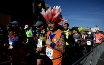 A competitor dressed as a Japanese cartoon character runs by the Colosseum at the start of the Rome Marathon on March 17, 2024. (Photo by Filippo MONTEFORTE / AFP) (Photo by FILIPPO MONTEFORTE/AFP via Getty Images)